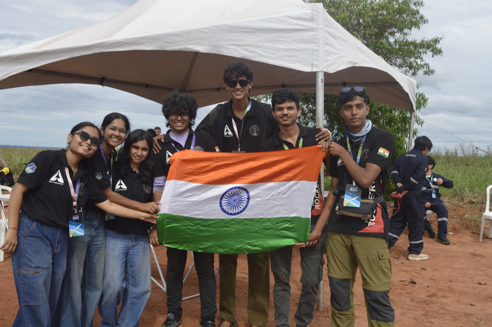 The STES Rocketry team holding the Indian flag